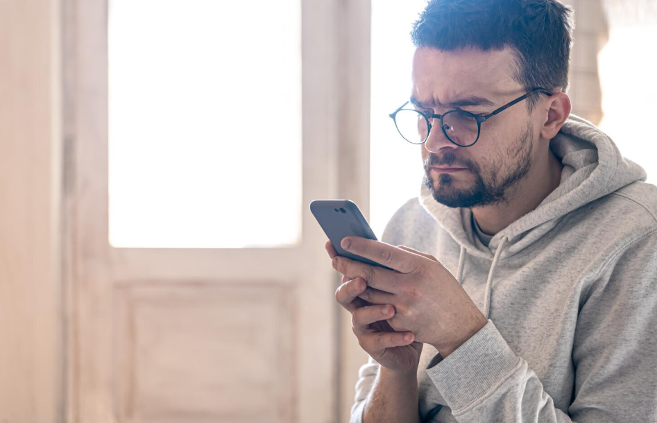 Parent using a phone while comparing preschool and childcare options