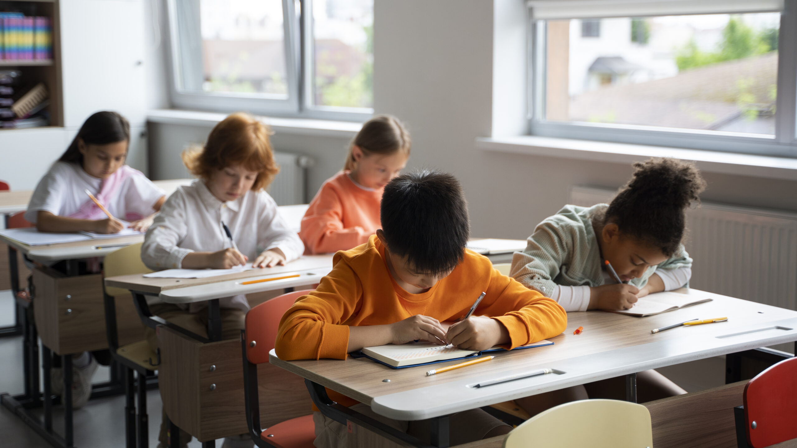 Teacher helping children in a classroom